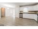 Eat-in kitchen, featuring white cabinets and wood-look flooring at 267 Wellington Walk, Douglasville, GA 30134