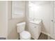 Clean bathroom features a granite vanity, updated toilet, and window at 267 Wellington Walk, Douglasville, GA 30134