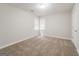 Bedroom with neutral carpeting and large window at 267 Wellington Walk, Douglasville, GA 30134