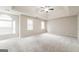 Spacious bedroom with ceiling fan and neutral carpeting at 267 Wellington Walk, Douglasville, GA 30134