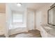 Bathroom with soaking tub and granite countertop vanity at 267 Wellington Walk, Douglasville, GA 30134
