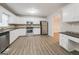 Bright kitchen with stainless steel appliances and white cabinets at 267 Wellington Walk, Douglasville, GA 30134