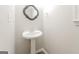 Charming pedestal sink with mirror in a small bathroom at 267 Wellington Walk, Douglasville, GA 30134