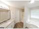 Main bathroom with shower, tub and granite vanity at 267 Wellington Walk, Douglasville, GA 30134