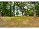 White house partially visible through lush green trees at 1042 Harbins Rd, Dacula, GA 30019