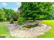 Landscaped backyard with a serene pond feature at 1042 Harbins Rd, Dacula, GA 30019