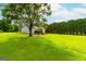 Two-story house with deck and expansive grassy yard at 1042 Harbins Rd, Dacula, GA 30019