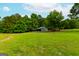 Metal building in a large grassy yard with trees at 1042 Harbins Rd, Dacula, GA 30019
