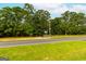 Roadside view of property with a treeline and road at 1042 Harbins Rd, Dacula, GA 30019