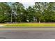 Roadside view of property with a treeline and road at 1042 Harbins Rd, Dacula, GA 30019