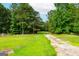 Large grassy field bordered by a tree line at 1042 Harbins Rd, Dacula, GA 30019