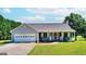 Ranch style home with attached garage and rocking chairs on the front porch at 1042 Harbins Rd, Dacula, GA 30019