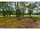 Property view from the road, showing a large lot with trees at 1042 Harbins Rd, Dacula, GA 30019
