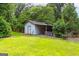 White storage shed in the backyard at 1042 Harbins Rd, Dacula, GA 30019