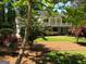 Two-story house with a large front yard, mature trees, and a long driveway at 2692 Peppermint Dr, Tucker, GA 30084