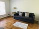 Bright bedroom with hardwood floors and a sofa bed at 2692 Peppermint Dr, Tucker, GA 30084