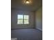 Spacious bedroom with neutral colored carpeting and large windows at 5700 Laney Dr, Rex, GA 30273