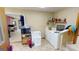 Laundry room with washer, dryer, and storage shelves at 5110 Macland Rd, Powder Springs, GA 30127