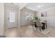 Elegant dining room with table and chairs, hardwood floors, and wainscoting at 659 Stately Dr, Woodstock, GA 30188