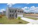 Two-story house with gray brick exterior, attached garage, and landscaping at 607 Whitman Lane # 203, Stockbridge, GA 30281