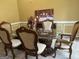 Formal dining room with a glass-top table and six chairs at 1221 Rhodes Sw Walk, Conyers, GA 30094