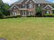 Brick house with a large front yard at 1221 Rhodes Sw Walk, Conyers, GA 30094
