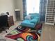 Relaxing bedroom with comfy chair, desk, and built-in shelving at 1221 Rhodes Sw Walk, Conyers, GA 30094