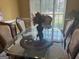 Bright dining room with a glass-top table and six chairs at 1221 Rhodes Sw Walk, Conyers, GA 30094