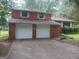 Brick ranch house with attached two-car garage at 7396 Meadows Dr, Riverdale, GA 30274