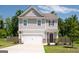 Two-story house with gray siding, white garage door, and a basketball hoop at 6904 Oak Valley Dr, Douglasville, GA 30134