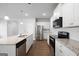 Open concept kitchen with white cabinets, granite counters and stainless steel appliances at 6904 Oak Valley Dr, Douglasville, GA 30134