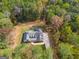 House nestled in a wooded lot, aerial view at 831 Banks Cir, Carrollton, GA 30116