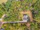 Aerial view showing house, driveway, and surrounding trees at 831 Banks Cir, Carrollton, GA 30116