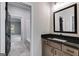 Modern bathroom with granite countertop, wood cabinets and a view to another bedroom at 831 Banks Cir, Carrollton, GA 30116