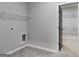Laundry room with built-in shelving and access to a large closet at 831 Banks Cir, Carrollton, GA 30116