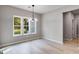 Bright dining room with large windows and modern chandelier at 831 Banks Cir, Carrollton, GA 30116