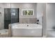 Relaxing bathroom featuring a soaking tub and a walk-in shower at 831 Banks Cir, Carrollton, GA 30116