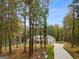 House nestled in a wooded area with a long driveway at 831 Banks Cir, Carrollton, GA 30116