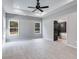 Large bedroom with ceiling fan, carpet, and ensuite bath access at 831 Banks Cir, Carrollton, GA 30116