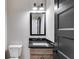 Simple bathroom with granite countertop and wood cabinets at 831 Banks Cir, Carrollton, GA 30116