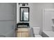 Small bathroom with tub, toilet and vanity with black countertop at 831 Banks Cir, Carrollton, GA 30116