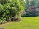 Brick home with a large green lawn and plenty of trees at 111 Fern Way, Canton, GA 30115