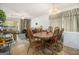 Combined dining and living room with a stone fireplace and wooden table at 8608 Creekwood Way, Jonesboro, GA 30238