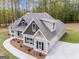 Two-story home with gray and beige siding, a large backyard, and a three-car garage at 1797 Star Point Rd, Carrollton, GA 30116