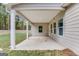 Covered patio with white columns offering tranquil wooded views at 1797 Star Point Rd, Carrollton, GA 30116