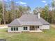 Rear view of charming house with covered patio and wooded backdrop at 1797 Star Point Rd, Carrollton, GA 30116