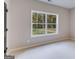 Serene bedroom with large windows showcasing a wooded view at 1797 Star Point Rd, Carrollton, GA 30116