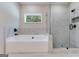 Bathroom with soaking tub, walk-in shower, and window at 1797 Star Point Rd, Carrollton, GA 30116