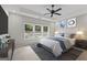 Main bedroom with plush carpet, window, ceiling fan, and styled furnishings at 1797 Star Point Rd, Carrollton, GA 30116