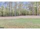 Wooded backyard with a cleared area perfect for recreation at 1797 Star Point Rd, Carrollton, GA 30116